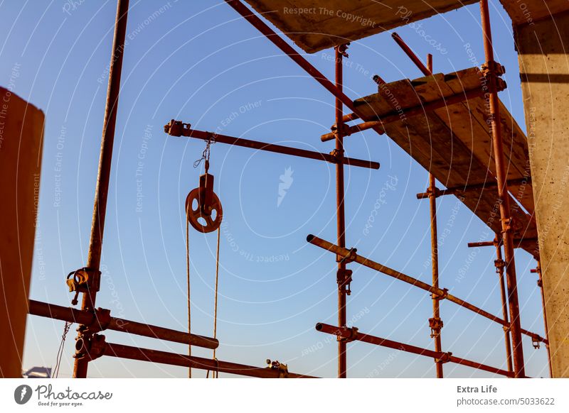 Round industrial pulley with rope for lifting load placed on the building site Bar Building Site Cable Cargo Carrier Carry Circle Circular Civil Engineering