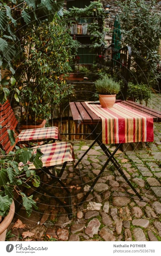 Table and chair on the terrace of a tavern in a garden table Outdoor furniture Terrace Garden chair Chair Seating Beer garden Restaurant Exterior shot Café