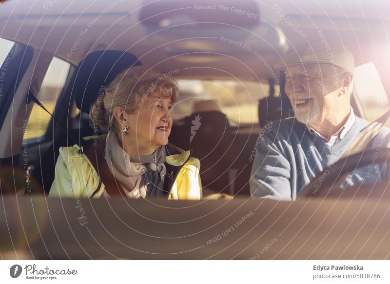 Elderly couple at the wheel of a car voyage Transport Car Street Car journey travel Trip Adventure Driver Public Holiday senior couple Woman two persons Couple