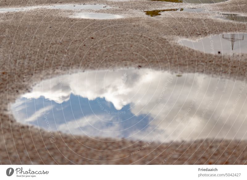 Reflection from blue sky with white clouds in a puddle puddle mirroring Puddle Water reflection Wet Weather Exterior shot Rain Deserted Colour photo Light Sky