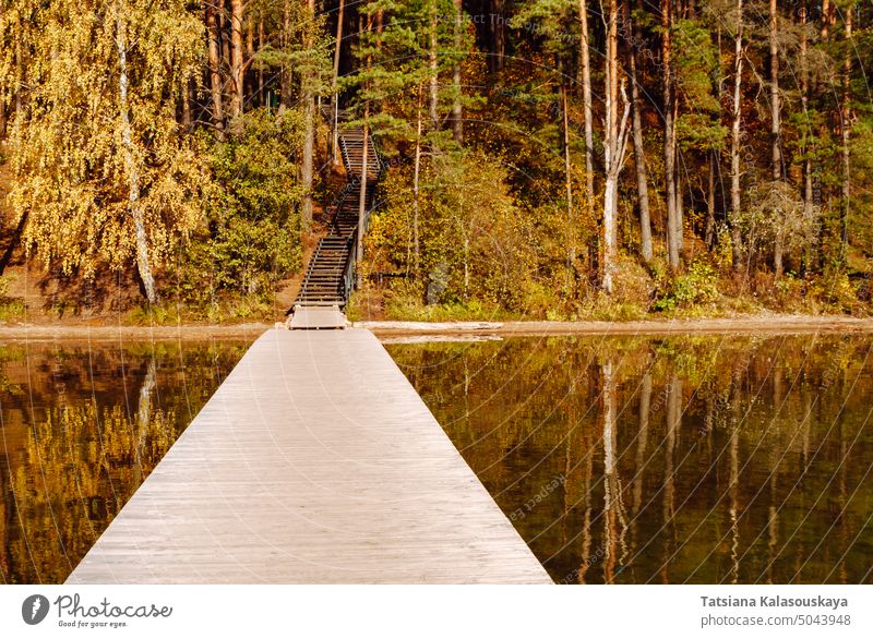 Wooden pier, autumn forest and wooden stairs up to a hill on Lake Baltieji Lakajai in Labanoras Regional Park, Lithuania Autumn Landscape Scenery Scenics Nature