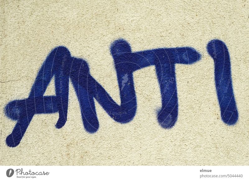ANTI is written in thick blue block letters on the house wall anti Against Graffiti on the other hand expression of opinion Cancelation Daub youth language