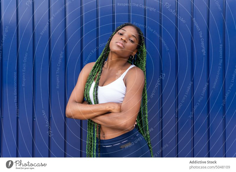 Premium Photo  Portrait of beautiful young woman standing with big braids  in her hair isolated on dark green background