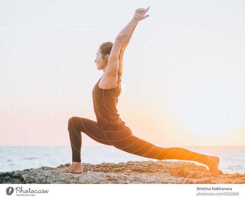 Slim Woman Lunging During Yoga Lesson by Stocksy Contributor Dreamwood  Photography  - Stocksy