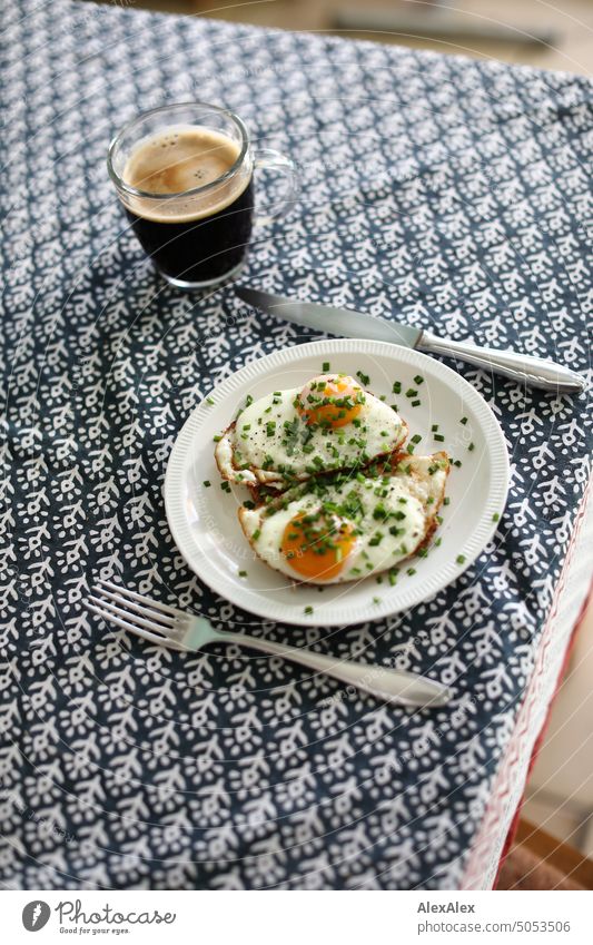 Set breakfast table - two fried eggs on bread with on a white plate with cutlery and glass coffee cup Eating Breakfast Meal Fried egg sunny-side up Fried eggs