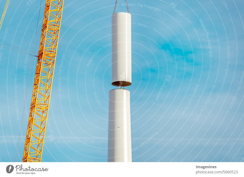 Erection and assembly of a wind turbine by crane. Construction work on the wind turbine at the Wörrstadt wind farm, Germany. Energy crisis concept, wind turbine construction