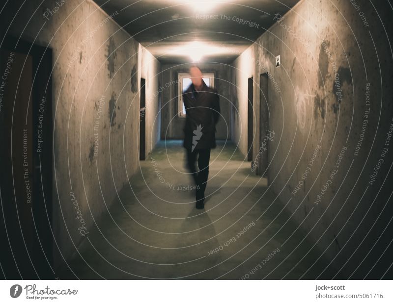a man in the hallway (prefabricated building) Man Architecture Gray motion blur Movement Wall (building) Human being Shadow Tunnel vision Going Lanes & trails