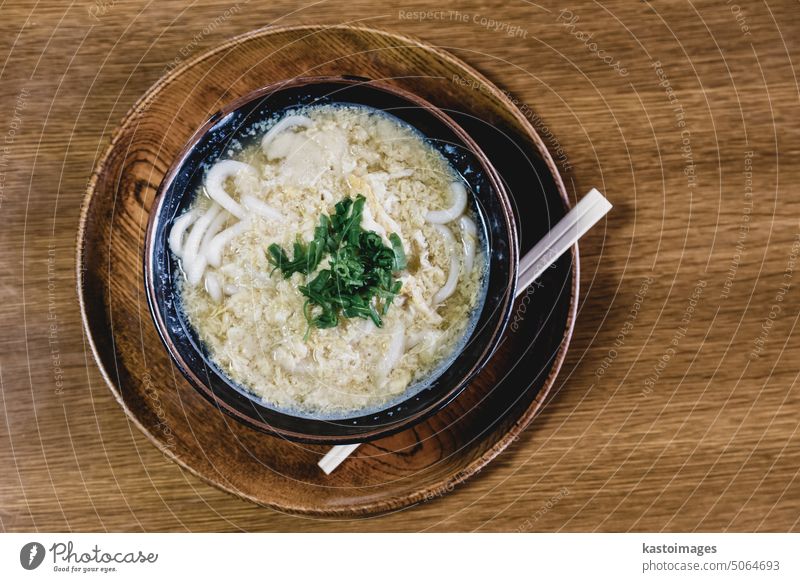 Miso Ramen Asian noodles with egg and parsley in wooden bowl on brown rustic background ramen meal japanese food asian lunch soup cuisine delicious chopsticks
