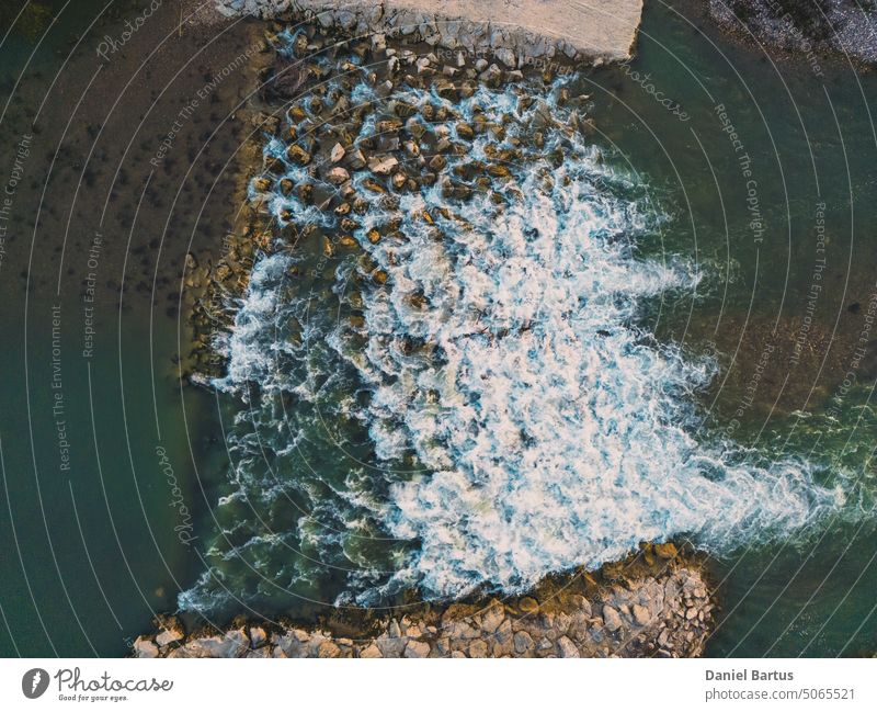 Beautiful Little Waterfall on the Drome River formed from great stones in a mountainous region. A waterfall during the sunset. Aerial Drone Shot abstract