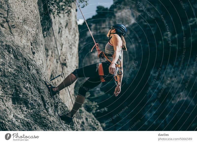 Woman descending a cliff after a climbing the wall active activity adventure andalusia athletic austrian climber committed effort endurance extreme
