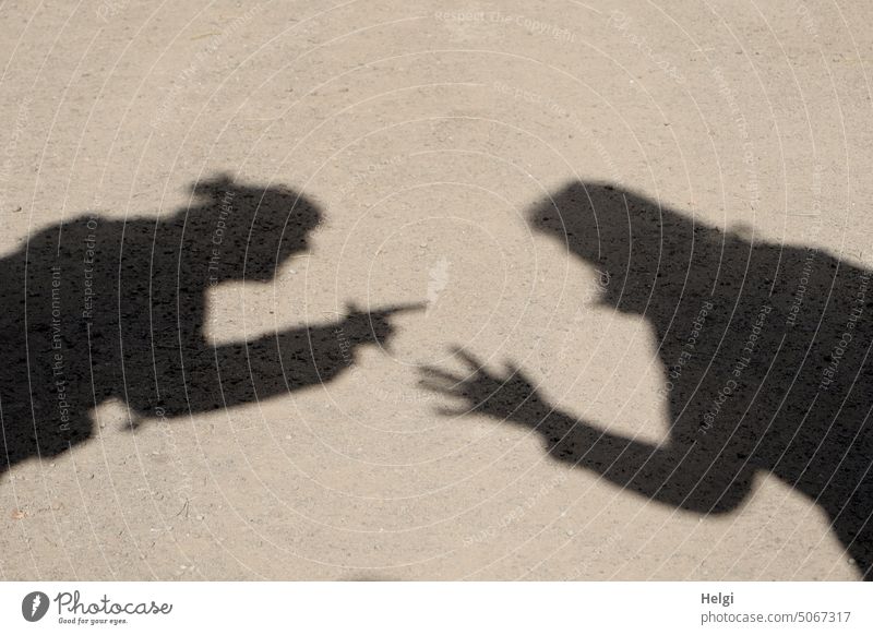 Shadow circus - shadows of two women gesticulating in the sand Shadow play Shadow Circus Woman Upper body Opposite Difference of opinion arm Hand Fingers