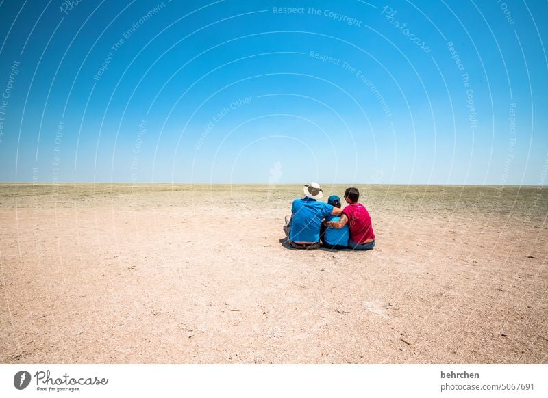 three people walking on a dune under cloudless sky - a Royalty Free Stock  Photo from Photocase