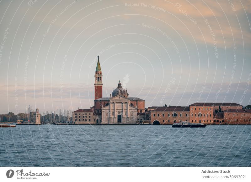 Old church against cloudy sky water symmetry historic island religion venice italy il redentore cathedral architecture shore evening canal overcast venezia