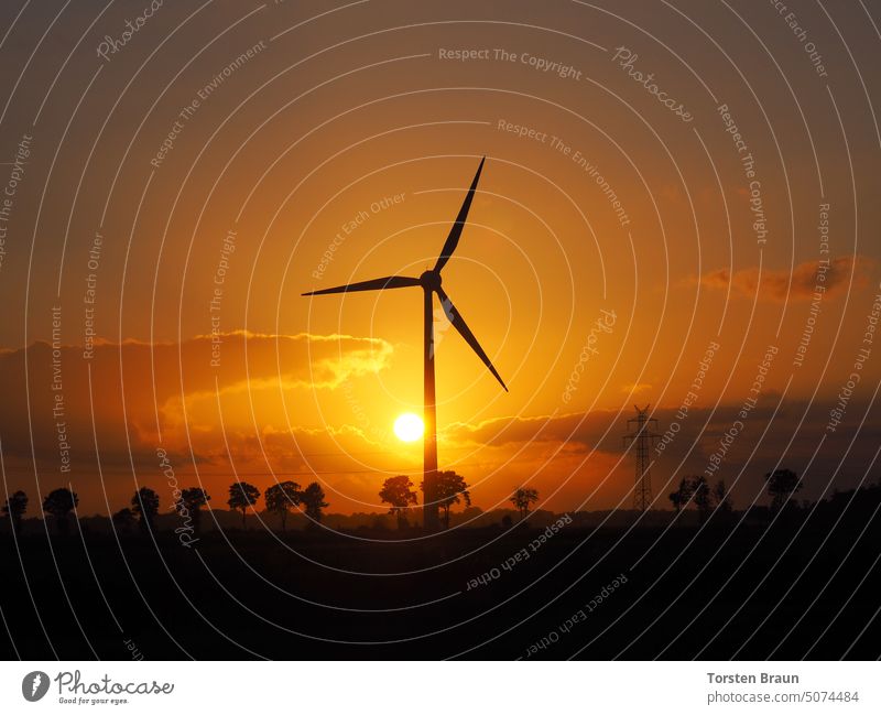 Energy supply of the future - Silhouette of a wind turbine in the sunset - The sun goes, but the wind stays. energy revolution Wind energy plant stream