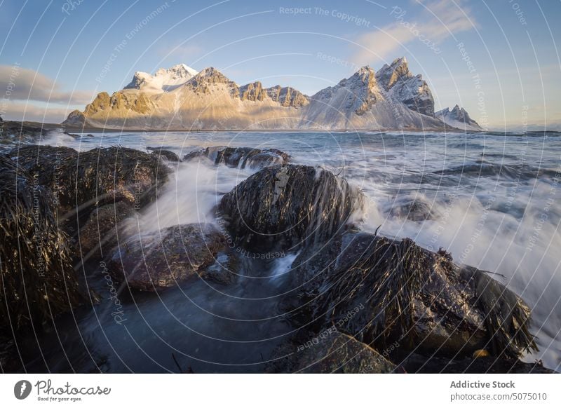 Amazing view of stormy sea and mountains wave nature landscape scenery picturesque sky coast shore snow iceland stockness beach rough water seashore rocky ocean