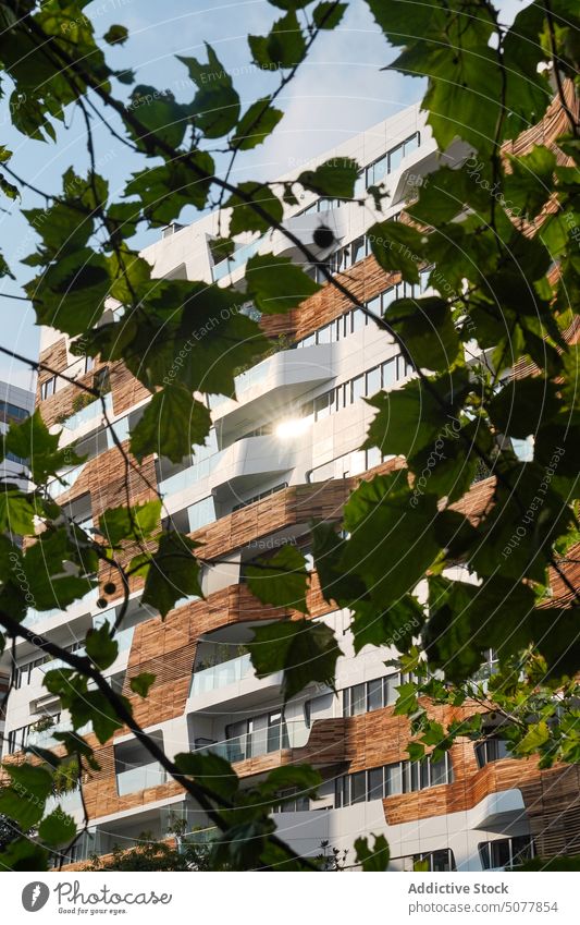 Modern apartment building against blue sky high rise modern street cloudy exterior facade architecture residential city contemporary construction district