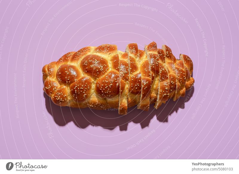 Sliced challah bread top view on a purple background Sabbath above baked bakery braided breakfast bright celebration close-up color crust cuisine cut out