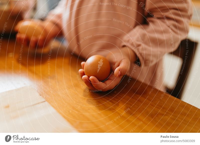 Child holding eggs Egg Hold Easter To hold on Hand Easter egg Close-up child Interior shot Infancy Food Cooking Baking Feasts & Celebrations Tradition