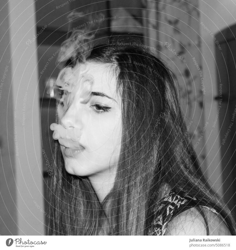 young woman exhales smoke Woman Young woman portrait Feminine Adults Youth (Young adults) Human being 1 18 - 30 years pretty Long-haired Interior shot smoking