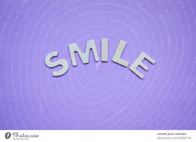 smile word on de purple background, feelings and emotions letters happy happiness notice message post it positive positivity greeting cheers text concept design