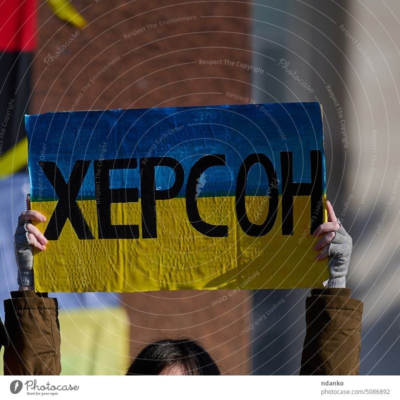 Women's hands hold a poster with the inscription Kherson kherson protest support ukraine war symbol ukrainian concept patriot city message help independence