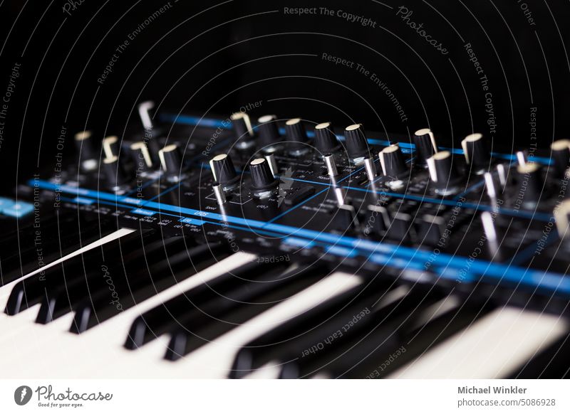 Synthesitzer in blue and black board business closeup data detail device digital electronic electronic equipment electronic instrument electronic music fader