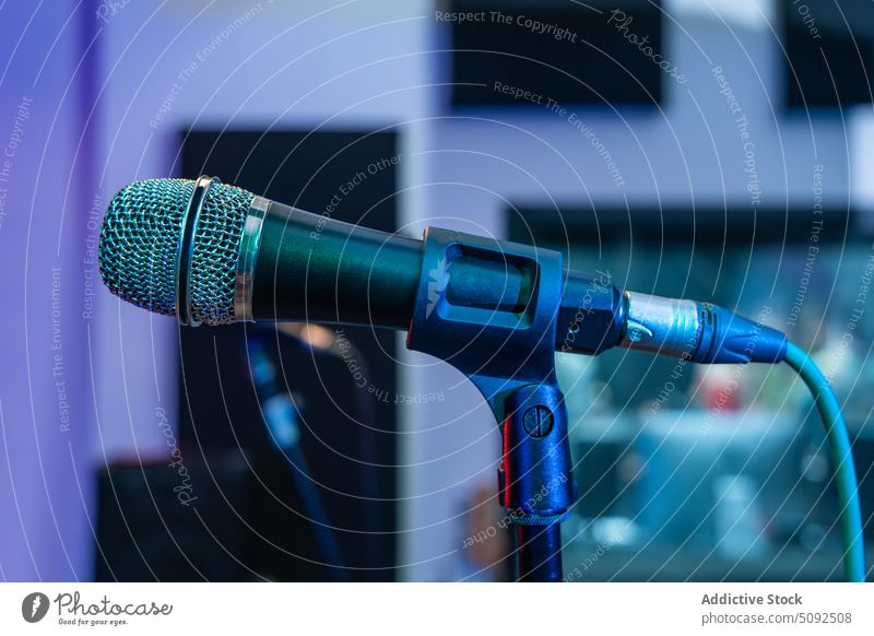 Modern microphone on counter in studio vocal song wire sound music garage loud rhythm rehearsal practice equipment tripod metal live creative voice broadcast