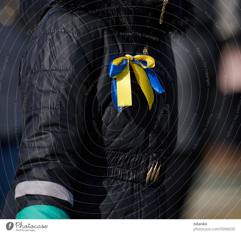 Yellow-blue ribbon on a black jacket, symbol of the Ukrainian flag victory yellow ukraine patriotism national patriotic peace conflict bow freedom ukrainian