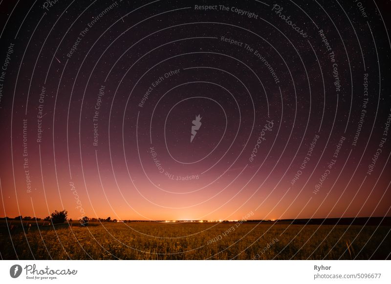 Natural Night Starry Sky Above Summer Field Meadow. Glowing Stars, Meteorite Trail And Sunset Sunrise Lights Above Meadow Landscape science yellow night