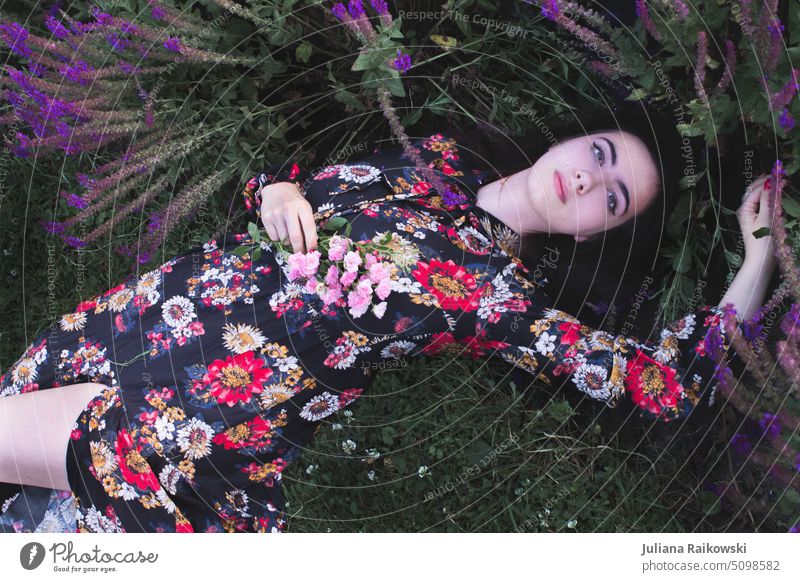 beautiful woman in summer dress is lying on flower meadow Style Uniqueness Hip & trendy Spring Face of a woman Beauty Photography Meditative Lifestyle portrait