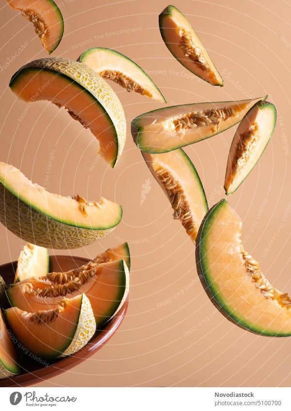 Slices of fresh melon falling, light background Melon Melone slice Fruit Wallpaper Delicious Colour photo Nutrition Vegetarian diet Diet food Juicy Green
