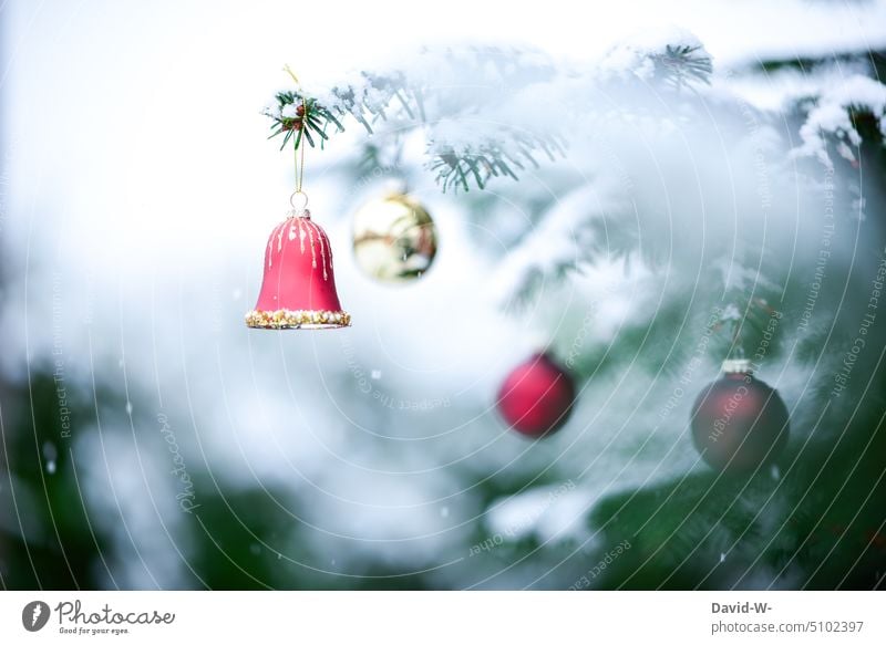 Christmas tree balls and bells in a snowy fir tree Snow baubles Bell Christmassy Snowfall Pensive enchanted Christmas mood christmas tree Festive