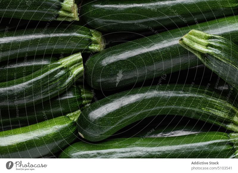 Closeup of ripe green zucchini vegetable squash raw fresh food uncooked long ingredient vegan healthy meal organic stack vitamin yummy palatable many bunch