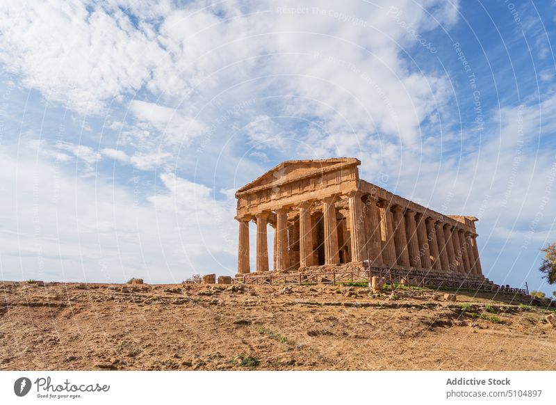 Ancient building with columns under cloudy sky historic sightseeing tourism architecture facade ancient heritage archaeology landmark agrigento sicily italy