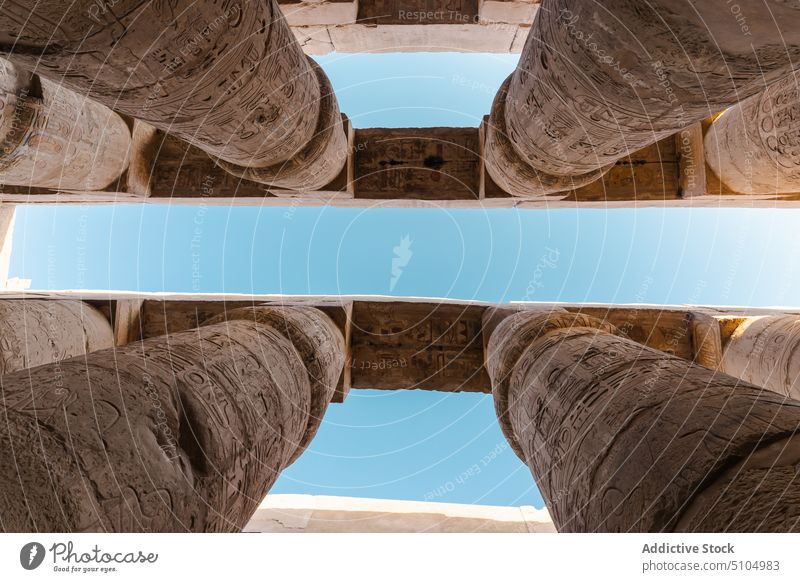 Ancient ornamental columns in old temple against blue sky architecture heritage historic culture landmark relief sightseeing travel ancient religion tourism