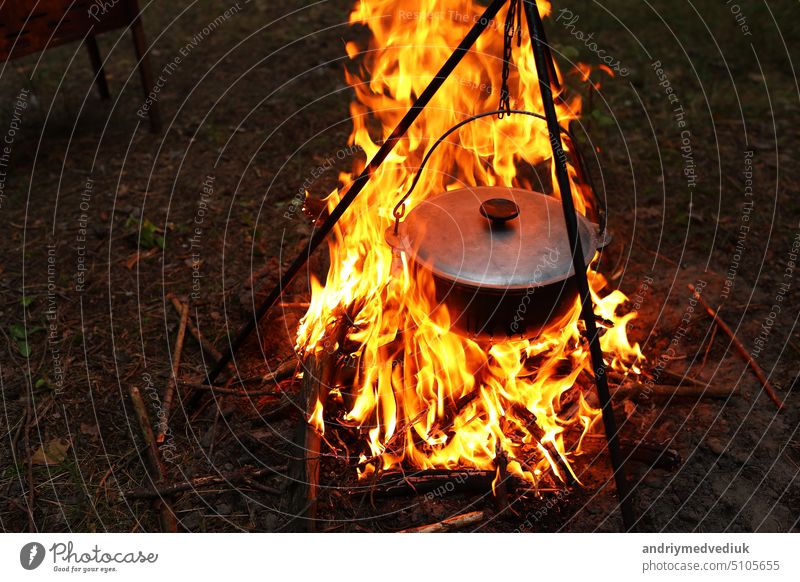 Cauldron or Camping Kettle Over Open Fire Outdoors Stock Image