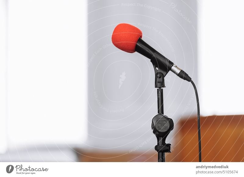 microphone on stage in business seminar, speech presentation, town meeting, lecture hall, conference room in corporate or community event. Business, education and technology concept. copy space