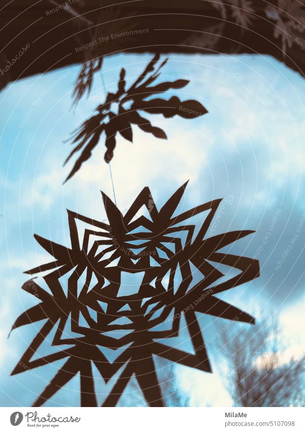 decorative christmas paper stars hanging as garland on window with blue sky in background Handicraft Decoration Leisure and hobbies Creativity Paper cut