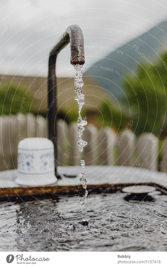 Water bubbles from a faucet Tap Drinking water Drops of water Sink Fluid drinking trough Wet Water cup neat Refreshment Cold drink Well Thirst