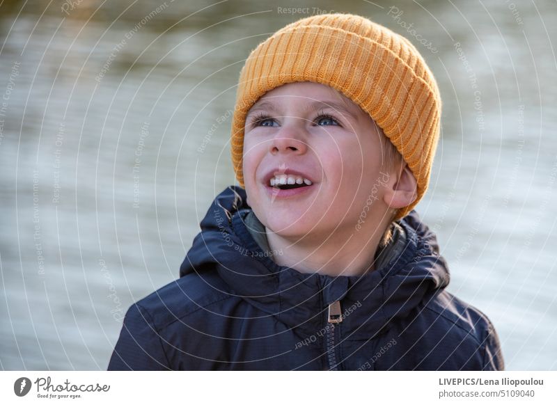 Young European boy 5 years old activity Autumn backgrounds Blonde blue eyes Car Hood Boy (child) Cap Easygoing Central Europe Child City City life Clothing Cold