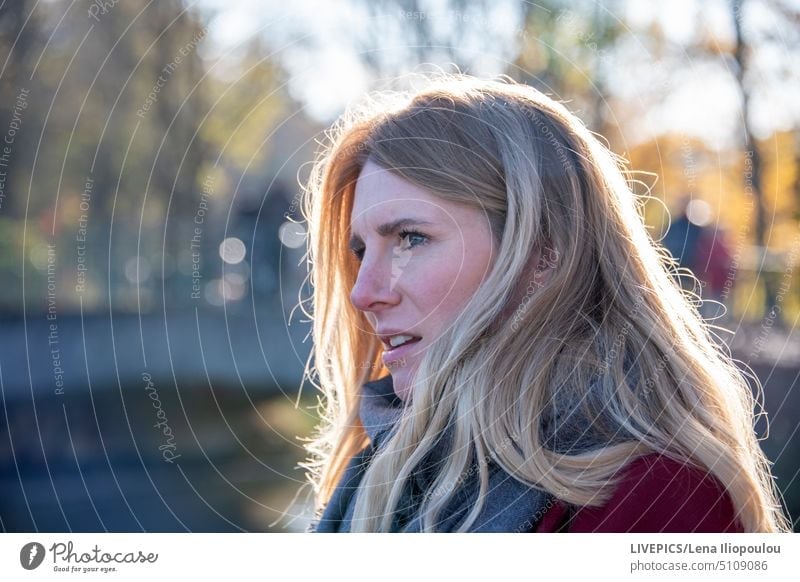 Side view headshot of a european young blond woman activity autumn backgrounds body part city city life clothing coat cold copy space dame day daylight dress