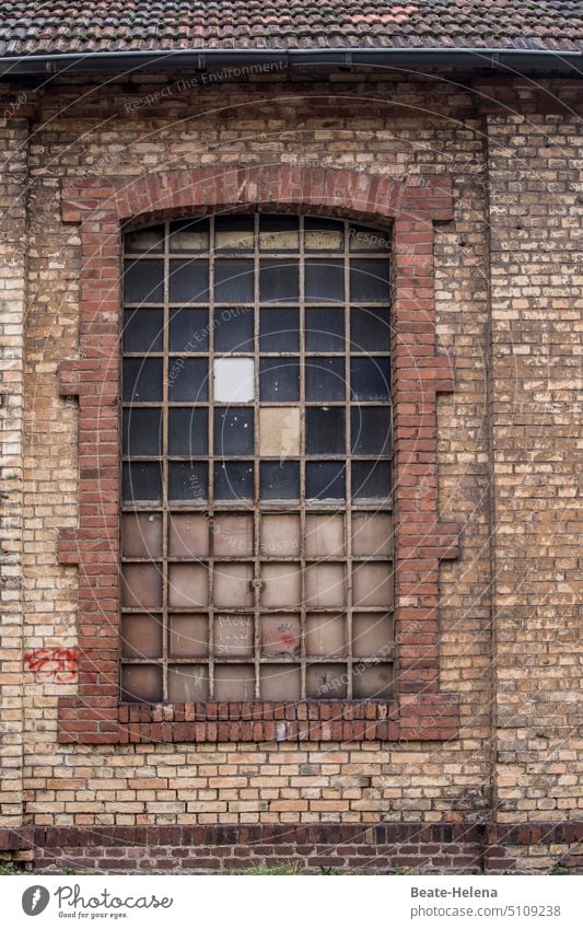 Old window with glass replacement Window brick building dilapidated mended Glass replacement no transparency Dreary Broken Decline Past Change Building