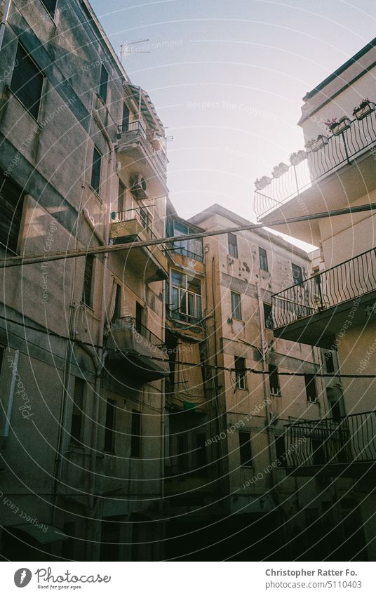 Sun falls on the facade of a residential building in southern Italy. Filmlook Tourism warm Tourist Sky Copy Space vacation Vacation mood movie Pressure Poster