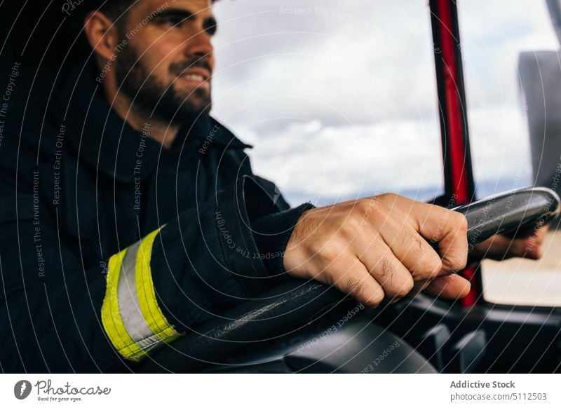 Hispanic fireman driving fire engine drive smile work emergency friendly uniform protect portrait male adult hispanic ethnic service positive professional job
