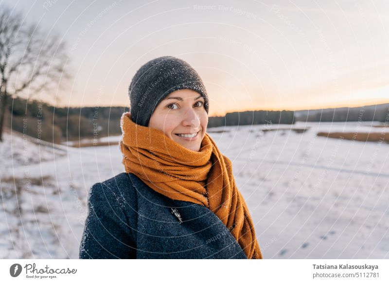 Young woman with Warm Clothes in Cold Winter Snow drinking coffee