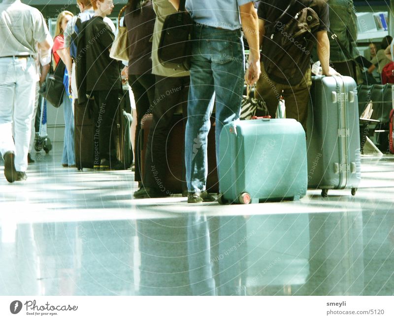 waiting Suitcase Vacation & Travel Turquoise Floor covering Bag Switch Waiting area Group Airport Human being Train station Warehouse Work and employment trolly