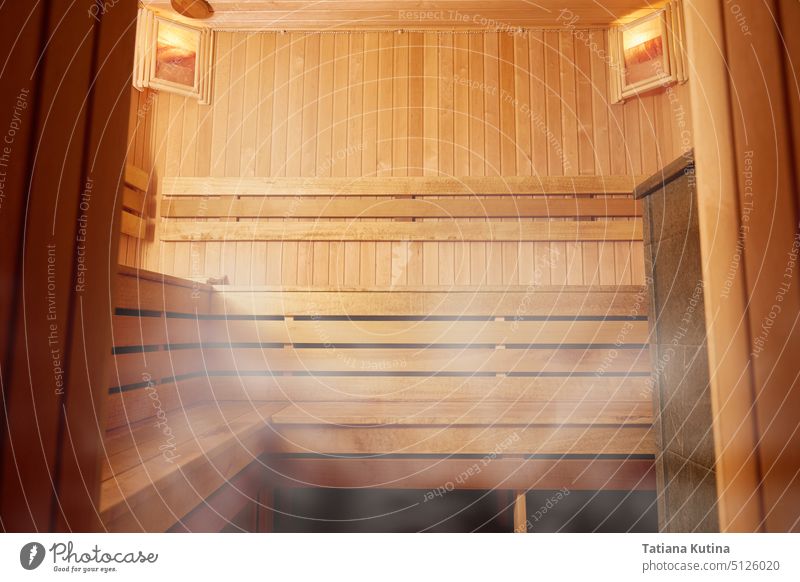 The interior of a wooden bathhouse, wooden shelving. opy space sauna hot relaxation finland temperature warm heat treatment hygiene wellness therapy inside