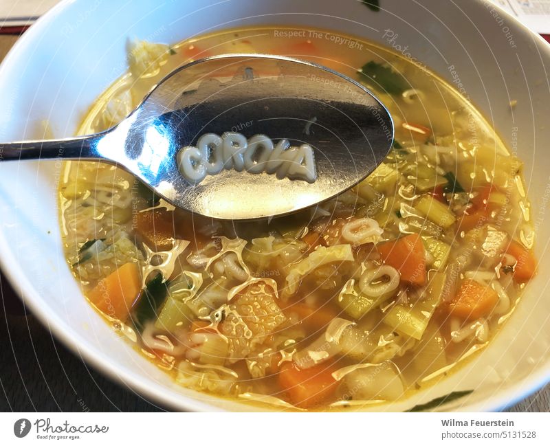 Soup with letter noodles, the word CORONA on the spoon corona Alphabet soup spoon out prophylaxis