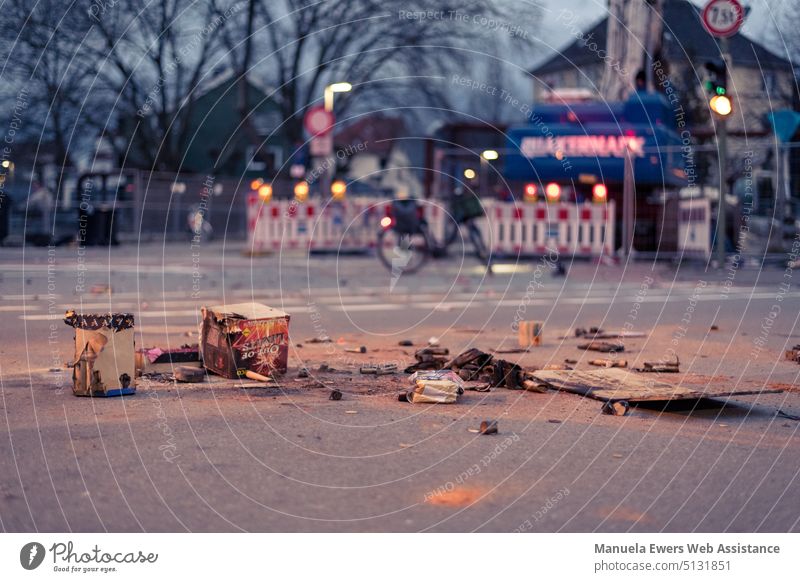 Remnants of a fired firework lie in the middle of the street the morning after. Firecracker New Year's Eve celebrations Construction site pyro Street center