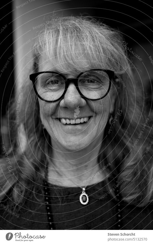 Looking to the future Black & white photo black-and-white portrait Eyeglasses Person wearing glasses laughing vivacious Woman middle age beauty ideal Aura